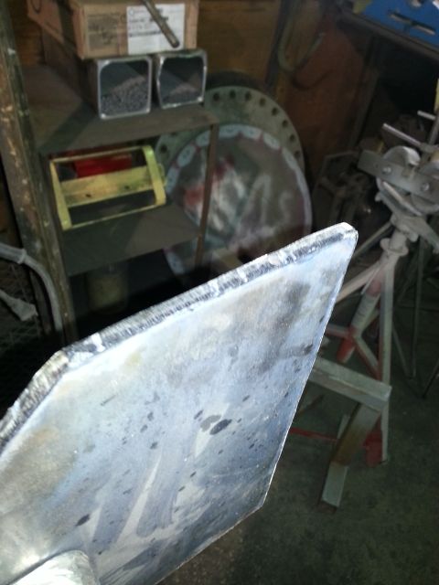1994 Ford Bronco - A close-up of a metal part in a workshop setting, with the Supermotors.net logo visible at the bottom right.
