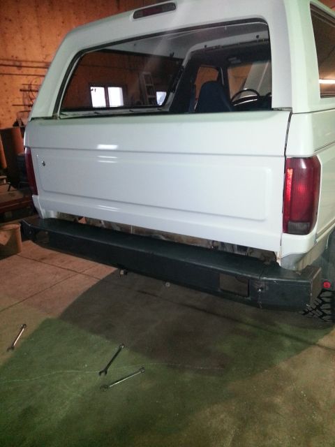 1994 Ford Bronco - Rear view of a white Ford Bronco, possibly undergoing repairs or modifications.