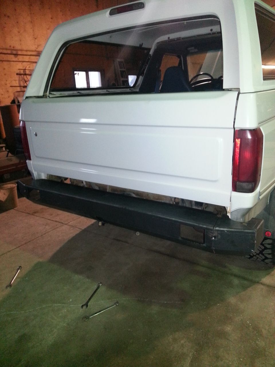 White Ford Bronco rear bumper and tailgate removed, showing interior