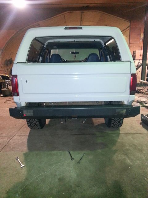 1994 Ford Bronco - This white SUV is parked indoors, possibly in a garage or workshop, with tools on the floor.
