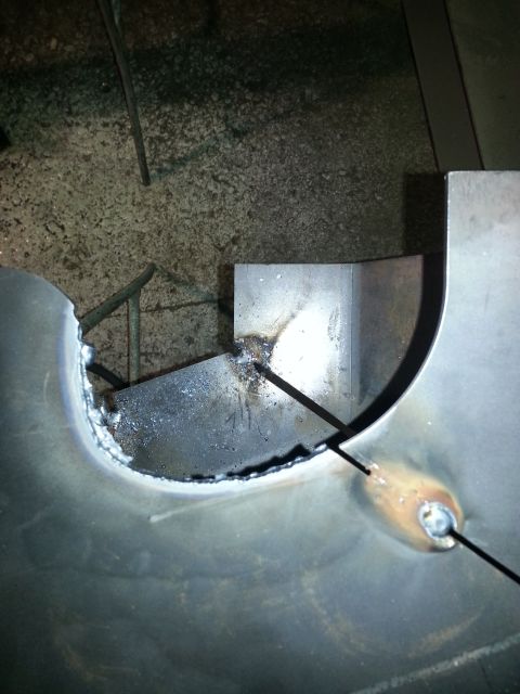 1994 Ford Bronco - Metal fabrication in progress, showing a welding operation with visible sparks and molten metal.