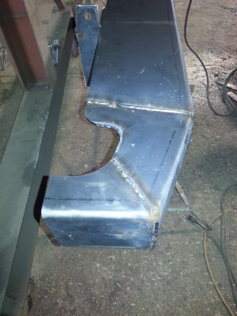 1994 Ford Bronco - A close-up view of a custom-fabricated metal part, likely a bumper or frame component, showing recent welding work.