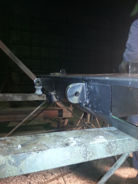 1994 Ford Bronco - A close-up view of a vehicle's frame, showing structural components and suspension attachment points.
