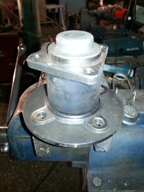 1994 Ford Bronco - A wheel hub assembly is secured in a vise, likely for repair or inspection.