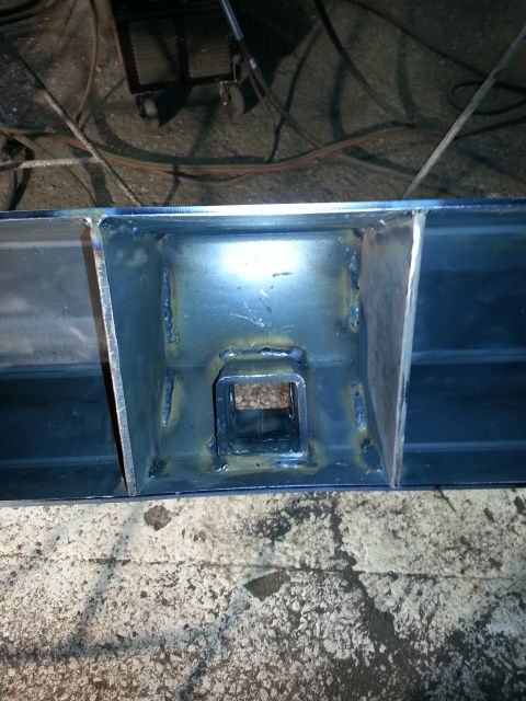 1994 Ford Bronco - Close-up of a custom-fabricated steel frame with a receiver hitch opening, showing welding details.
