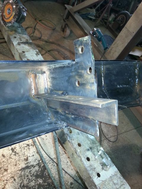 1994 Ford Bronco - Close-up of a welded metal frame, likely part of a vehicle chassis, with a bracket and mounting holes visible.