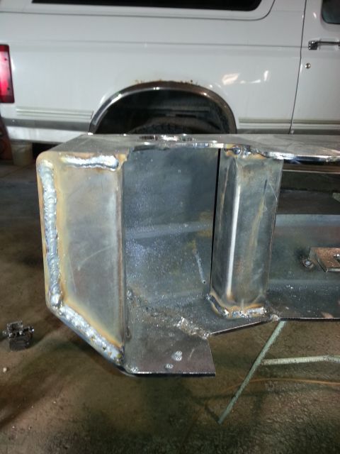 1994 Ford Bronco - A custom metal bumper is being welded onto a white Ford Bronco.