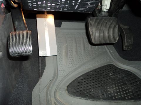 2004 Mercury Grand Marquis - Interior view of the footwell in a 2004 Mercury Grand Marquis, showing pedals and fuse box.
