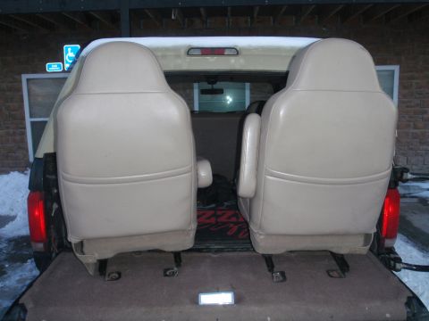 1994 Ford Bronco - Interior seats loaded into the cargo area of a vehicle during winter.