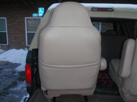 1994 Ford Bronco - Interior view of a vehicle's back seat, with snow visible outside.