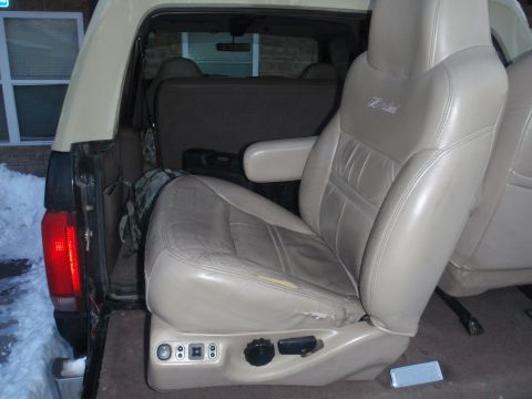 1994 Ford Bronco - Interior view of a 1994 Ford Bronco, highlighting the leather seats with "Limited" badging and power seat controls.