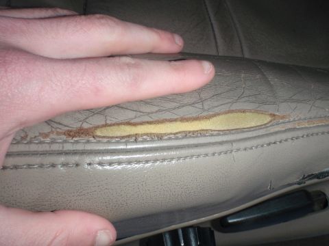 1994 Ford Bronco - The driver's seat upholstery is ripped, revealing the foam underneath.