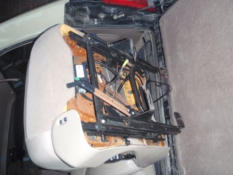 1994 Ford Bronco - Close-up of a removed car seat mechanism, showing springs and wiring.