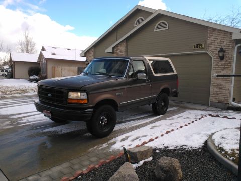 1992 Ford Bronco - This 1992 Ford Bronco is shown in a driveway with snow on the ground and a house in the background.