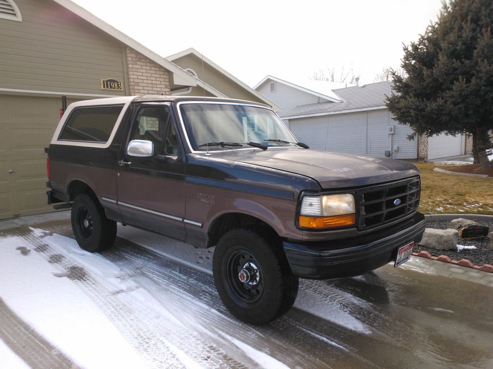 1992 Ford Bronco parked in driveway with snow on the ground