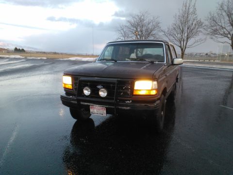 1992 Ford Bronco - A 1992 Ford Bronco is seen from the front on a wet, overcast day.