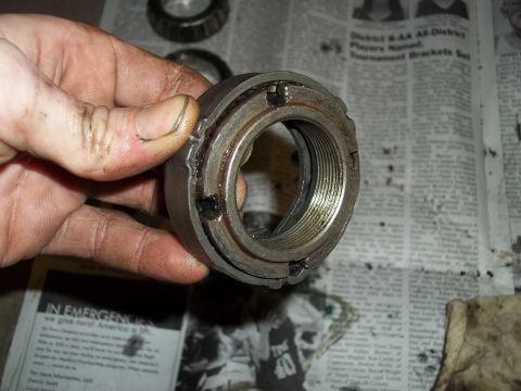 1990 Ford Bronco - Close-up of a wheel bearing lock nut, likely removed during maintenance or repair.