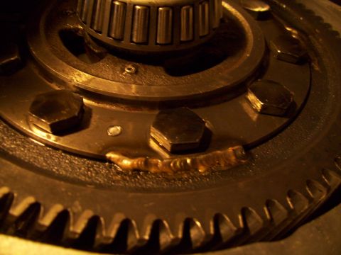 1995 Ford Probe - A close-up view of a vehicle's mechanical component, showing gears, bolts, and a bearing.