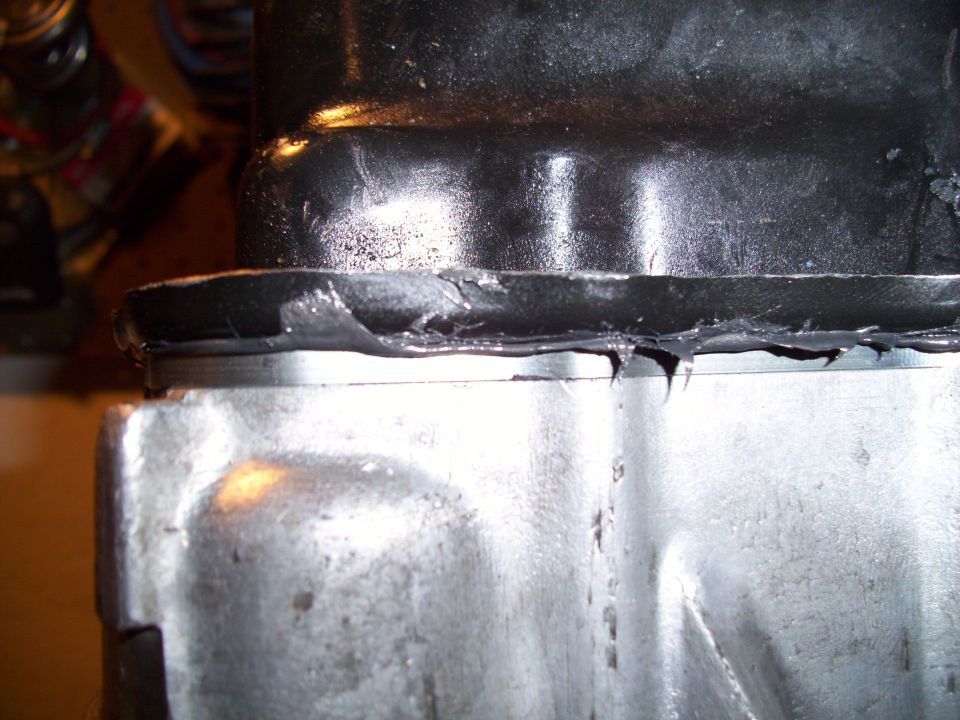 Engine part with black gasket material squeezed out