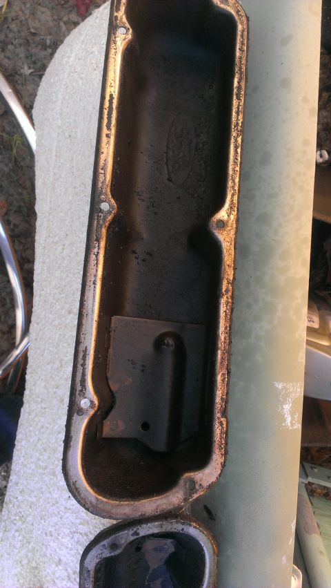 1990 Ford Bronco - This is a close-up view of a used Ford valve cover, showing internal buildup and a baffle plate.