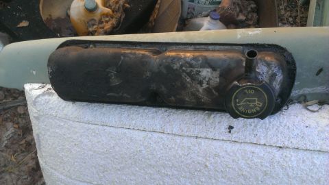 1990 Ford Bronco - Close-up of an engine valve cover with a "ENGINE OIL" cap, likely from a Ford vehicle.