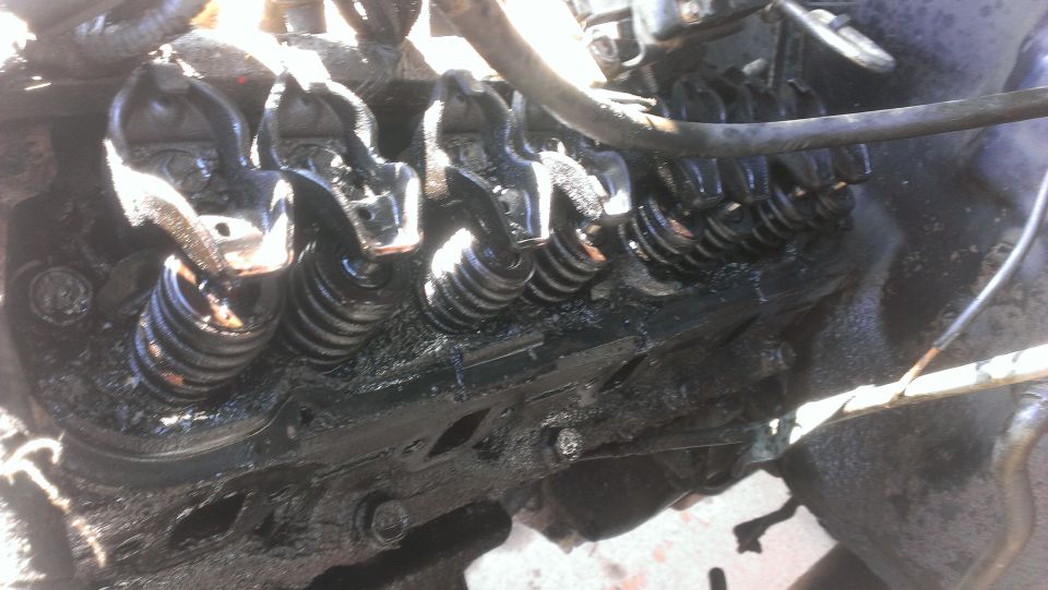 Close-up of engine valve train with oil buildup