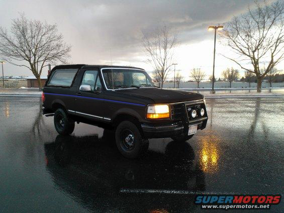 1992 Ford Bronco parked on wet asphalt, front quarter view
