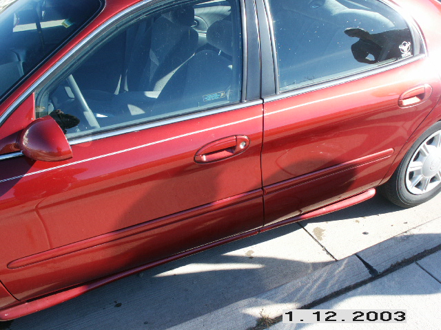 side view of a red sedan's front door and rear door