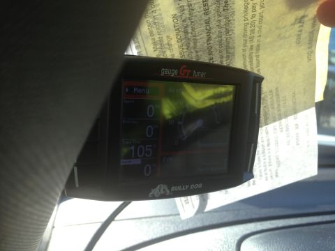 2008 GMC Sierra 3500 - The Bully Dog GT Tuner gauge displays vehicle data, including speed and economy readings.