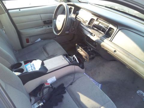 2006 Ford Crown Victoria - Interior of a 2006 Ford Crown Victoria, the dashboard, steering wheel, and front seats.
