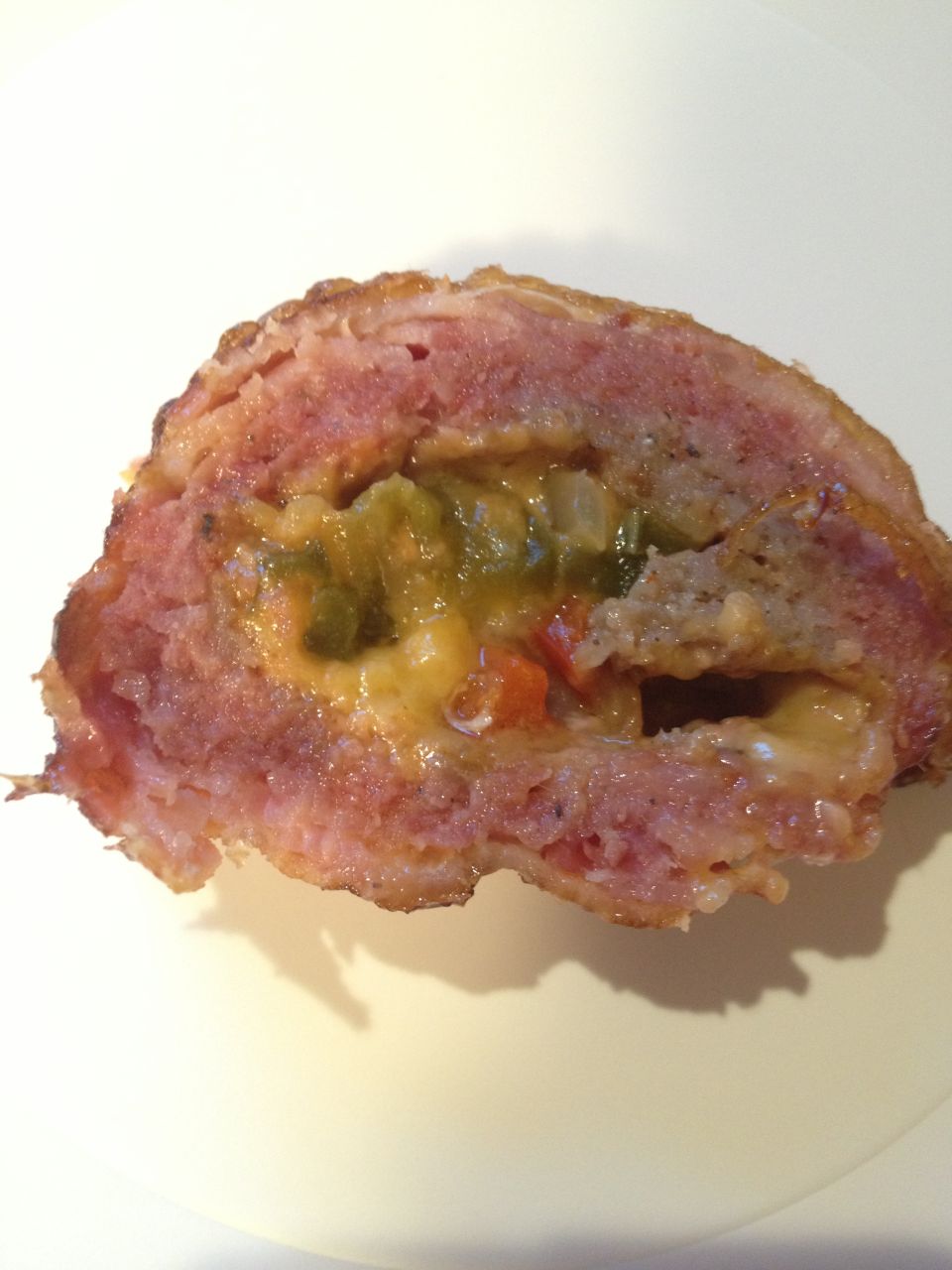 slice of meatloaf stuffed with cheese and chopped peppers