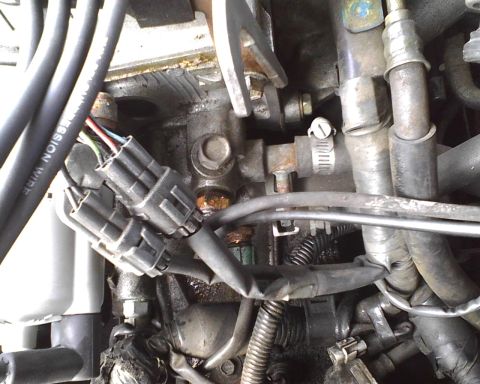 1991 Toyota Celica - Close-up view of engine components, including electrical connectors and hoses. The image contains text indicating the website SUPERMOTORS.N…