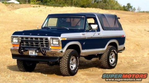 1994 Ford Bronco - This two-tone Ford Bronco features a prominent grille, aftermarket bumper, and a removable soft top.