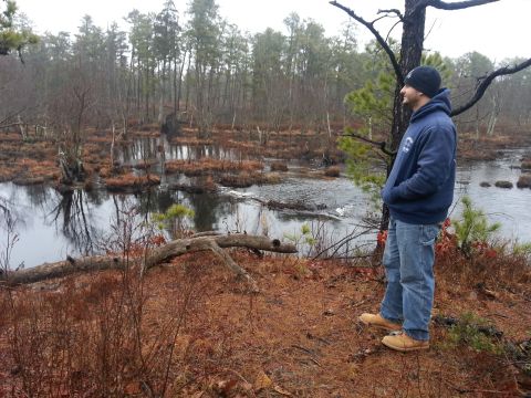 1987 Toyota 4Runner - Man surveys a swampy forest landscape on an overcast day.