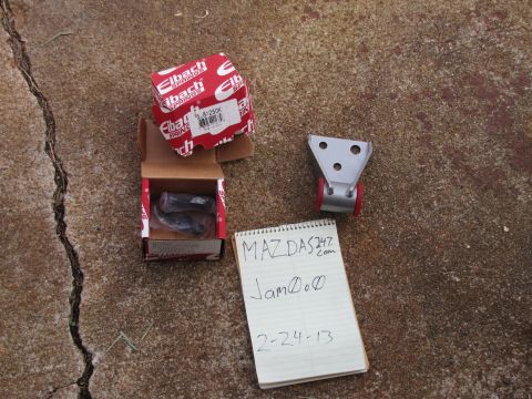1995 Ford Bronco - A box of Eibach springs and a suspension component are laid out on a concrete surface.