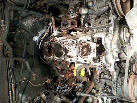 1987 Toyota 4Runner - Close-up of an engine block with cylinders exposed, revealing internal mechanical parts.
