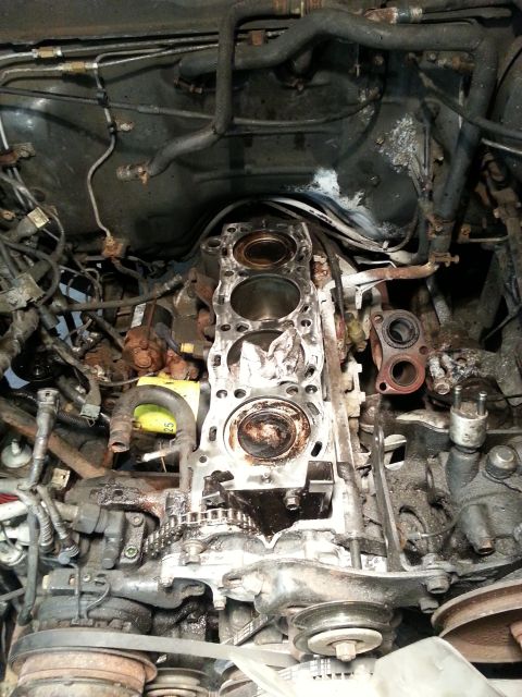 1987 Toyota 4Runner - The engine's cylinder head has been removed, exposing the pistons and internal components for maintenance or repair.