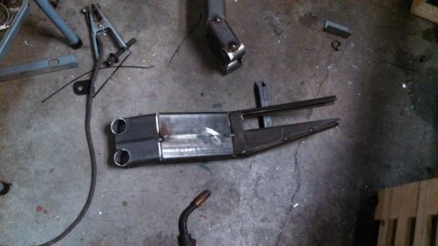 1967 Ford F-250 - A custom-fabricated metal component, likely for a vehicle or machinery, sits on a concrete floor.