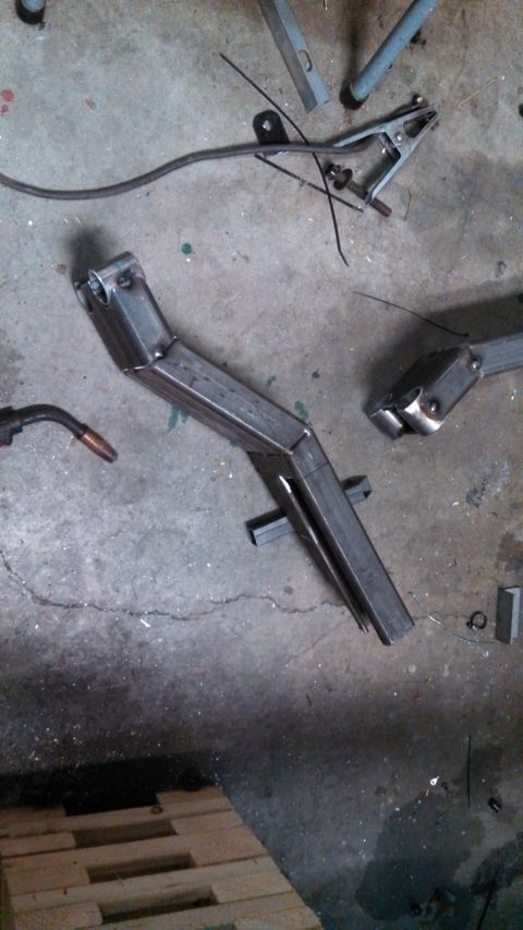 1967 Ford F-250 - A fabricated metal component rests on a workshop floor near welding equipment.