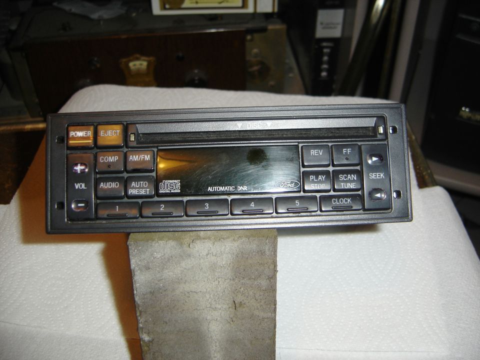 Ford factory radio head unit removed from dash, faceplate with preset, seek and tune buttons