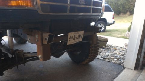 1995 Ford Bronco - Custom bumper mount on a truck, with a white SUV in the background.