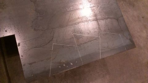 1995 Ford Bronco - A metal sheet is marked with chalk lines to guide a cut, suggesting a fabrication process.