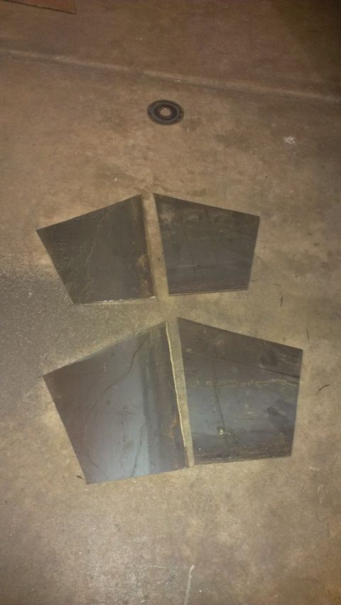1995 Ford Bronco - Four metal plates are laid out on a concrete floor, possibly for a project.
