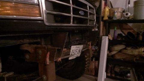 1995 Ford Bronco - The front grille and bumper of a Ford truck are visible, with a custom bumper modification.