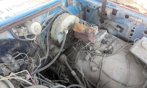 1994 Ford Bronco - Close-up of a vehicle's engine bay, focusing on the brake system components and wiring.