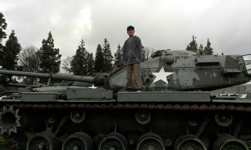Person standing on a military tank with a white star insignia