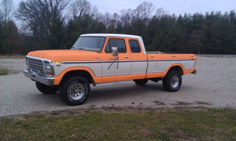 1994 Ford Bronco - This two-tone orange and white Ford F-Series pickup truck is shown from a three-quarter front perspective.