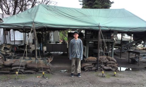 1994 Ford Bronco - A boy stands in a military-themed outdoor scene with sandbags and a large tent.