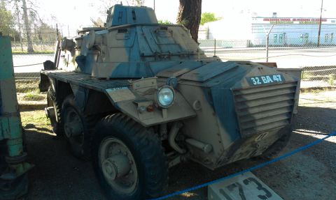 1994 Ford Bronco - Armored car with a turret and multiple wheels is parked outdoors.