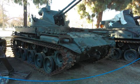 1994 Ford Bronco - This M19 Gun Motor Carriage, equipped with a twin Bofors gun turret, is displayed outdoors next to another military vehicle.
